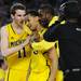 Michigan freshman Nik Stauskas, sophomore Trey Burke and fifth-year senior Corey Person celebrate beating No.1 seed Kansas, 87-85 in overtime of their Sweet 16 match up at Cowboys Stadium in Arlington, Texas on March 29, 2013. Melanie Maxwell I AnnArbor.com